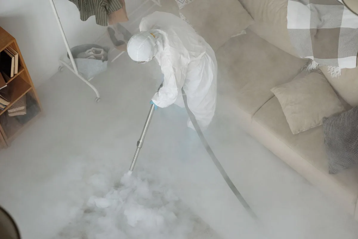 Biohazard cleanup technician in protective equipment, Gilbert, IA